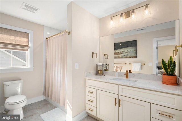 bathroom featuring tile patterned floors, a shower with curtain, toilet, and vanity