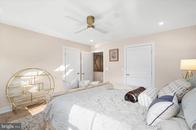 bedroom featuring ceiling fan, baseboards, wood finished floors, and recessed lighting