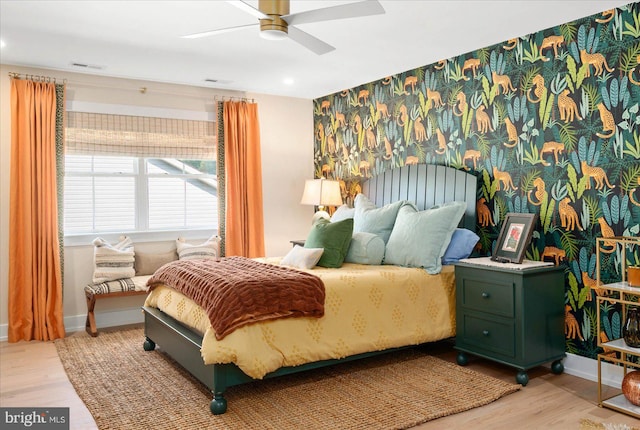 bedroom with ceiling fan and light hardwood / wood-style floors