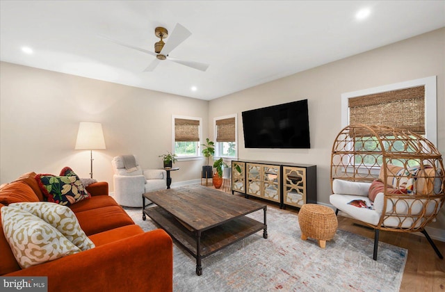 living room featuring ceiling fan and hardwood / wood-style flooring