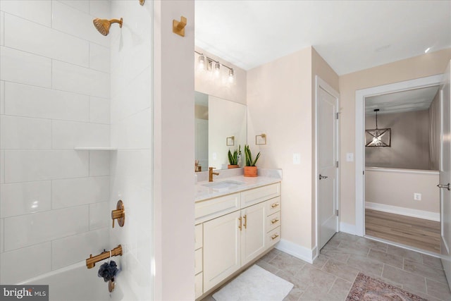 full bath with a shower, vanity, and baseboards