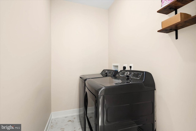 clothes washing area featuring washer and clothes dryer