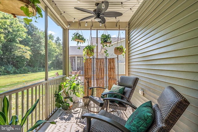 sunroom featuring ceiling fan