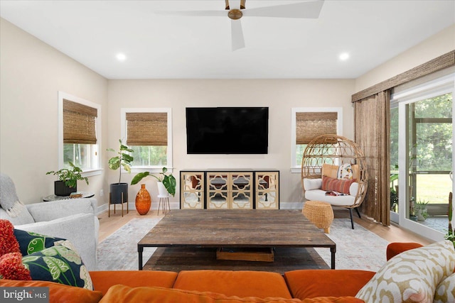 living room featuring light wood-type flooring and ceiling fan