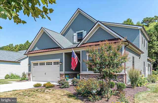 craftsman inspired home featuring driveway, stone siding, roof with shingles, an attached garage, and board and batten siding