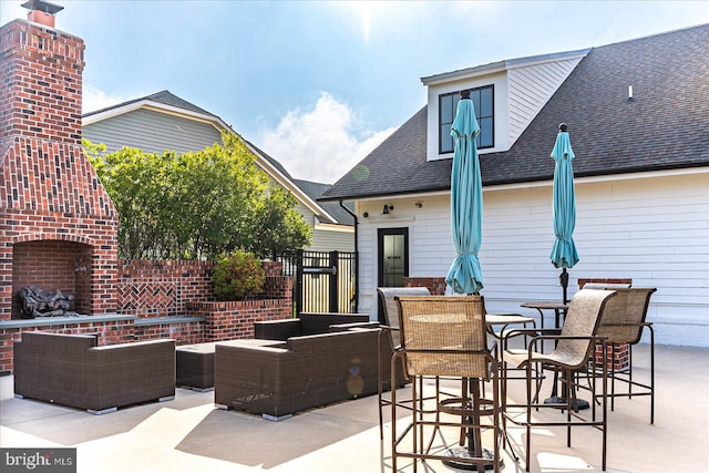 view of patio featuring an outdoor living space with a fireplace