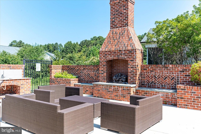 view of patio with an outdoor living space with a fireplace