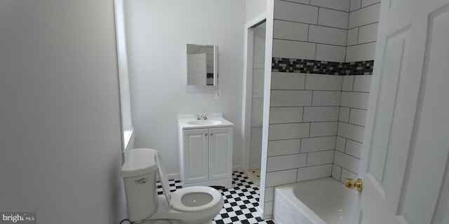 full bathroom featuring tiled shower / bath, vanity, and toilet