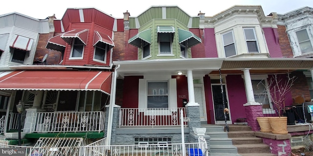 view of property featuring covered porch