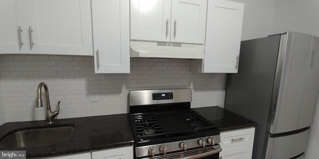 kitchen with white cabinets, appliances with stainless steel finishes, custom range hood, and sink