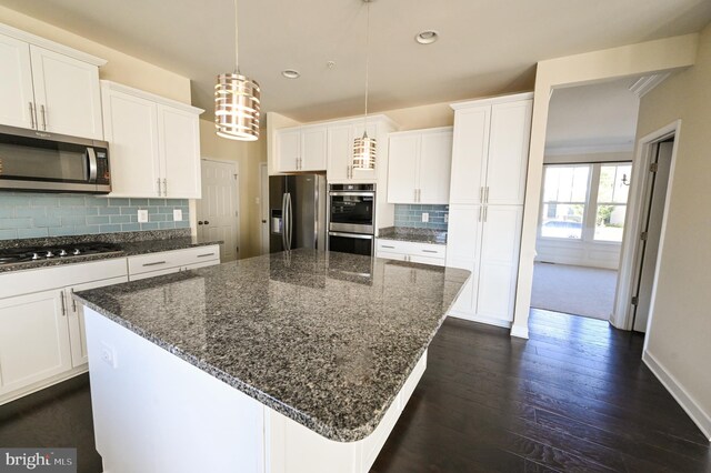 kitchen with stainless steel appliances, decorative backsplash, dark hardwood / wood-style floors, and white cabinets