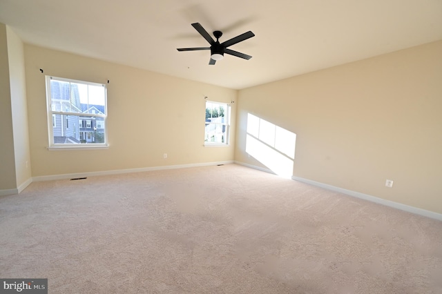 empty room with ceiling fan and carpet flooring