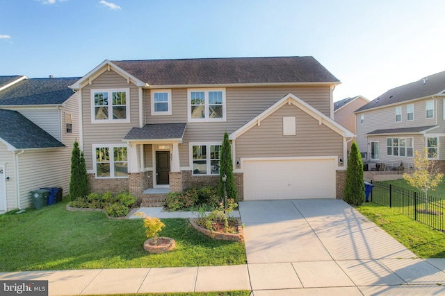 view of front facade with driveway, a front yard, fence, and brick siding