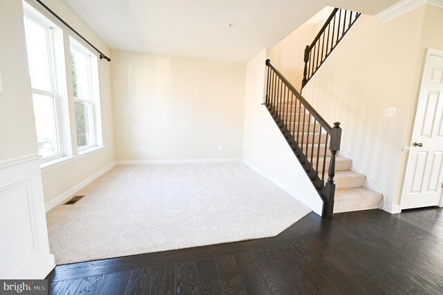 interior space featuring hardwood / wood-style flooring and ornamental molding