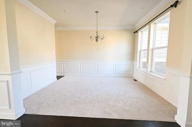 unfurnished dining area with a notable chandelier, plenty of natural light, and ornamental molding