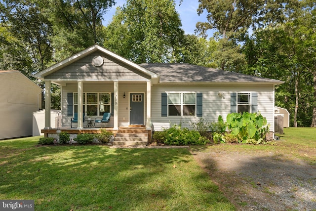 bungalow-style house with a front yard and covered porch