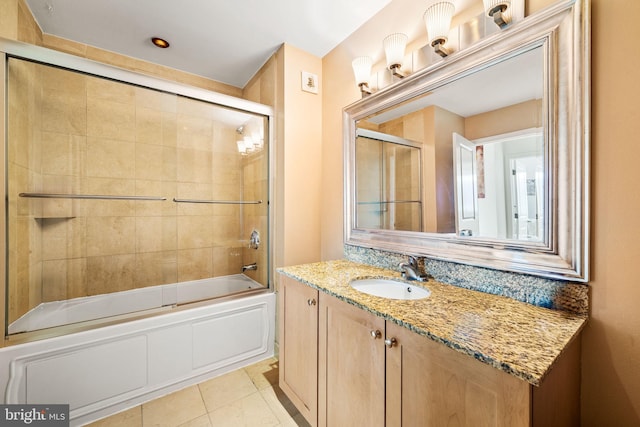 full bathroom with shower / bath combination with glass door, vanity, and tile patterned floors