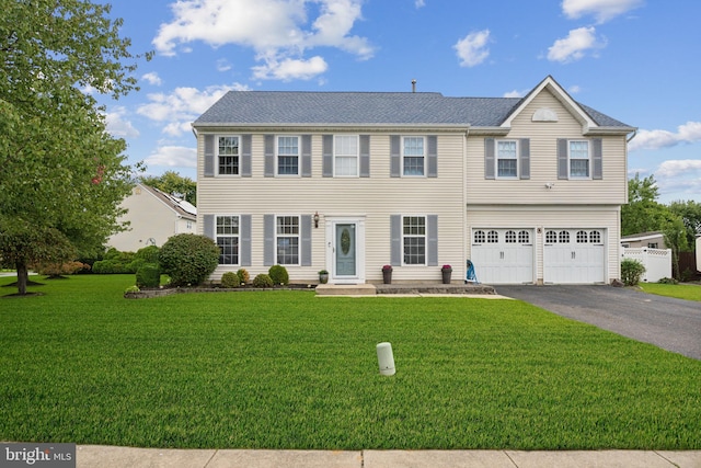 view of front of house with a garage and a front yard