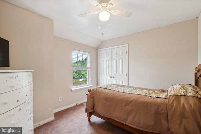 bedroom with ceiling fan, a closet, vaulted ceiling, and carpet