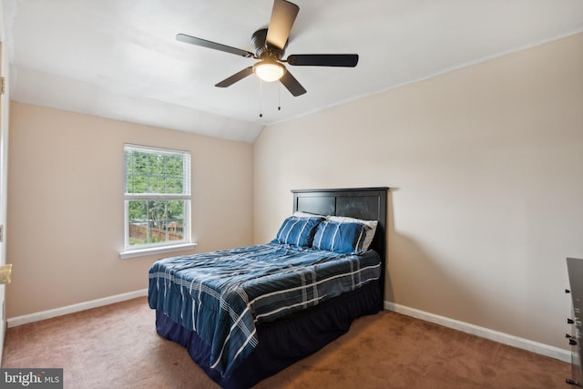 carpeted bedroom with vaulted ceiling and ceiling fan