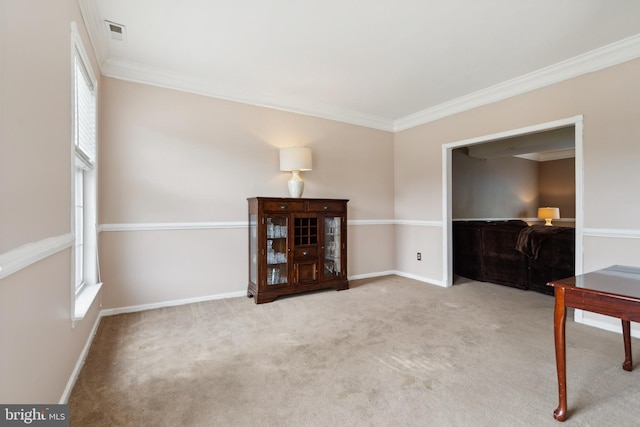 sitting room with light colored carpet and crown molding