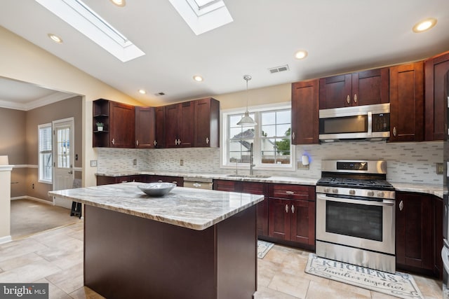 kitchen with stainless steel appliances, backsplash, sink, and lofted ceiling