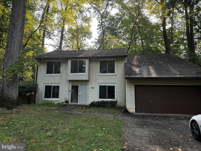 view of front of house with a garage and a front lawn