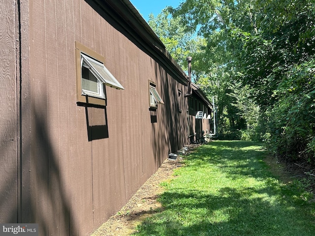 view of side of property with a yard