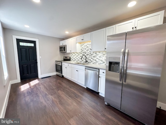 kitchen featuring dark hardwood / wood-style floors, sink, stainless steel appliances, and decorative backsplash