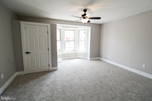 carpeted empty room with ceiling fan