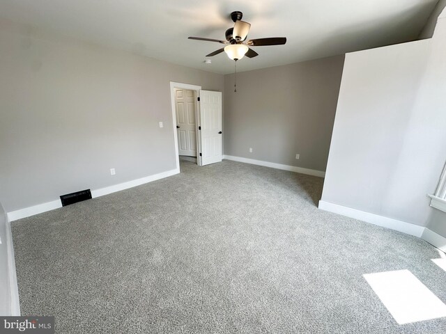 empty room with ceiling fan and light colored carpet