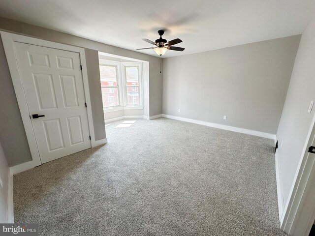 unfurnished bedroom featuring ceiling fan and light carpet