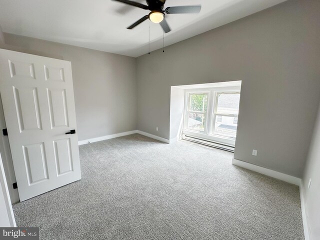 empty room featuring ceiling fan and carpet