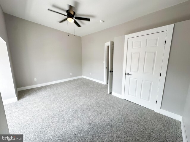 unfurnished bedroom featuring carpet floors and ceiling fan