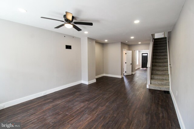 empty room with dark hardwood / wood-style flooring and ceiling fan