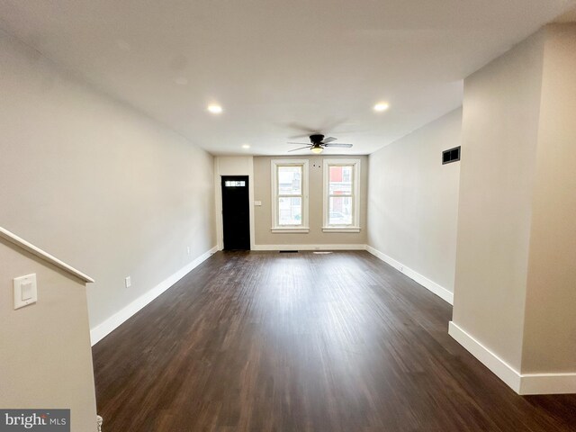 empty room featuring ceiling fan and dark hardwood / wood-style floors