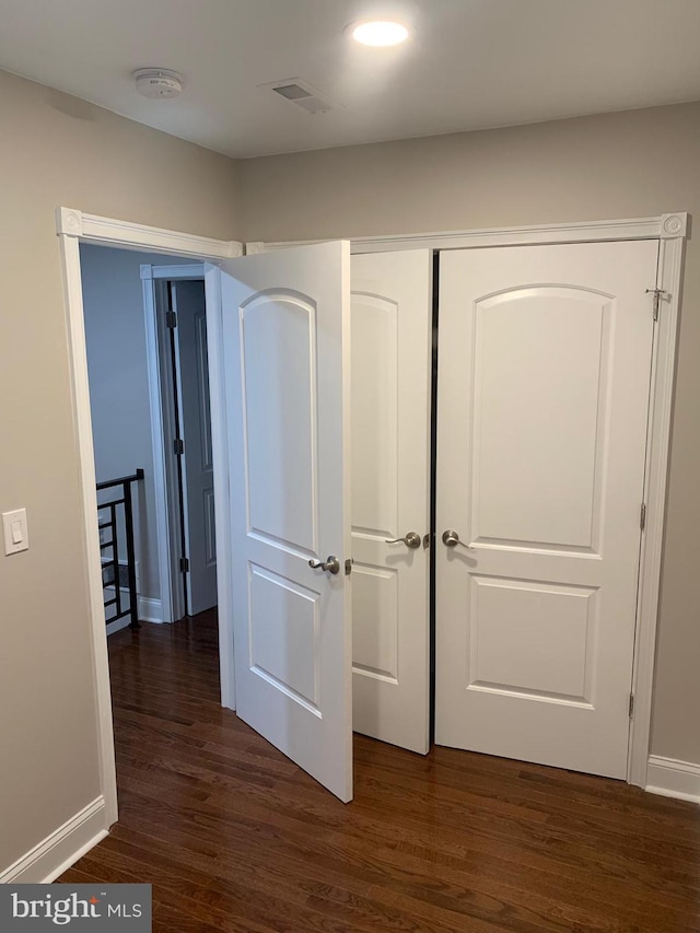 hallway with dark hardwood / wood-style floors