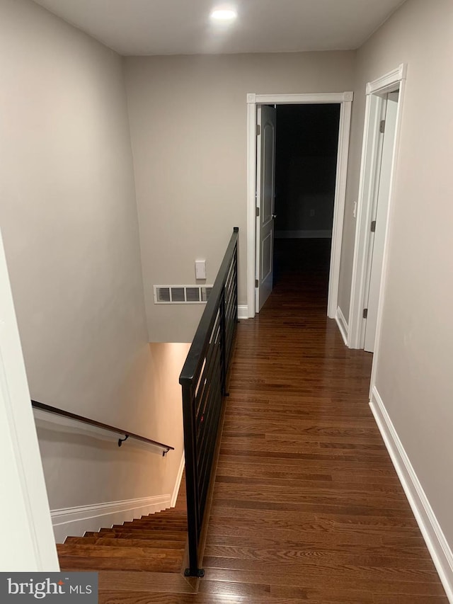 stairway featuring wood-type flooring