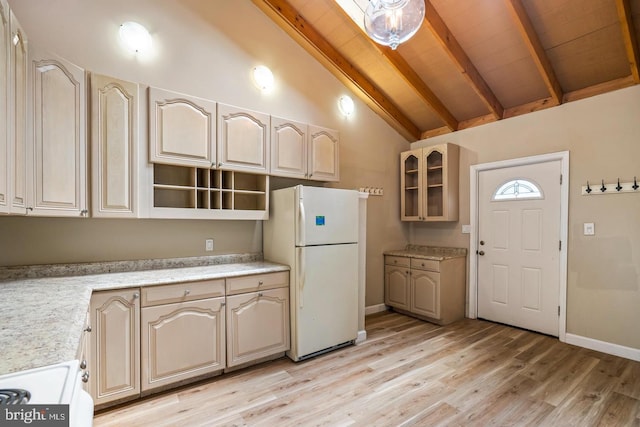 kitchen with white appliances, beamed ceiling, and light wood-type flooring