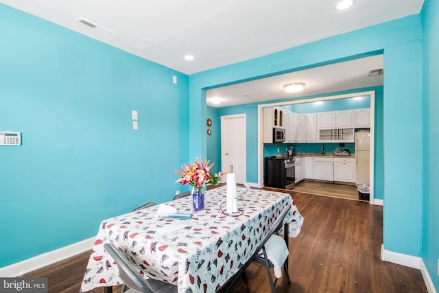 dining room with dark wood-type flooring