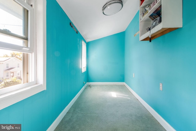 interior space featuring carpet flooring and vaulted ceiling