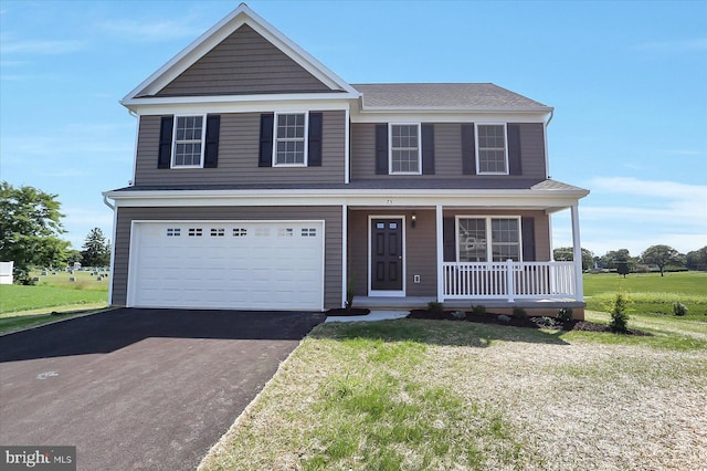 traditional-style home featuring aphalt driveway, covered porch, a front lawn, and a garage