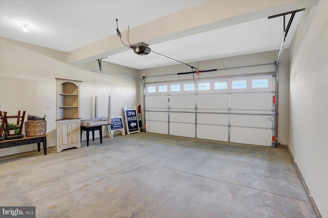 garage with baseboards and a garage door opener