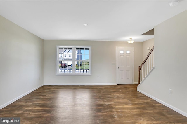 entryway featuring dark wood-style floors and baseboards