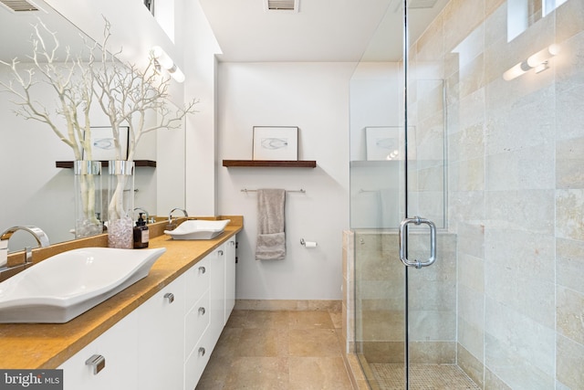 bathroom with vanity and an enclosed shower