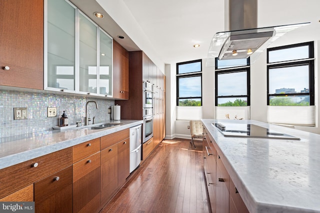 kitchen with sink, tasteful backsplash, light stone counters, dark hardwood / wood-style floors, and electric stovetop