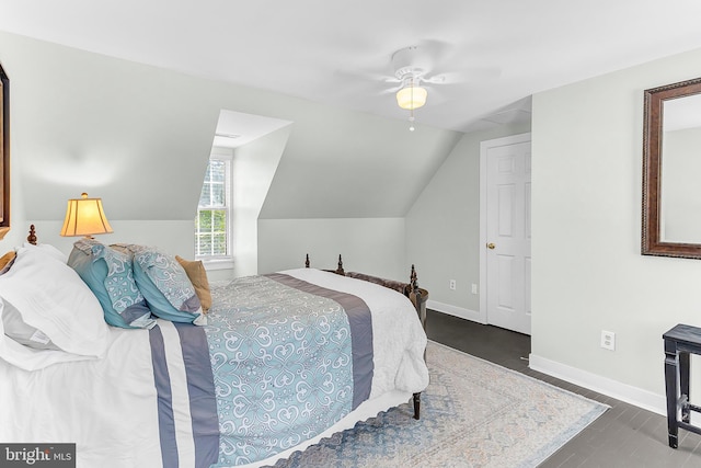 bedroom with vaulted ceiling, dark hardwood / wood-style floors, and ceiling fan