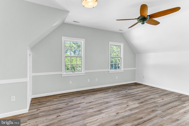 bonus room featuring lofted ceiling, light hardwood / wood-style floors, and ceiling fan