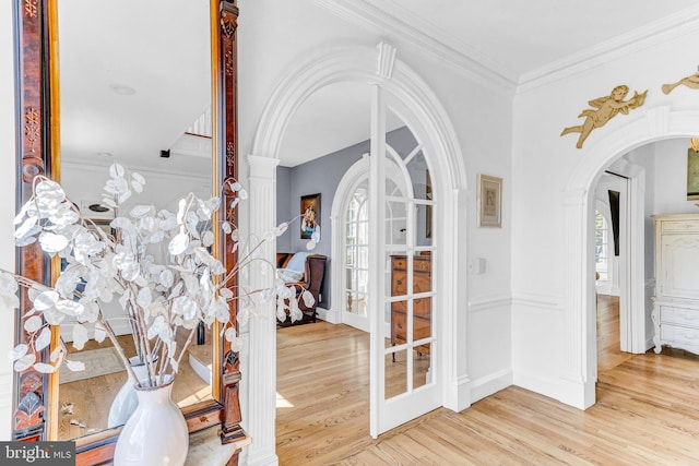 foyer featuring french doors, light hardwood / wood-style flooring, and ornamental molding