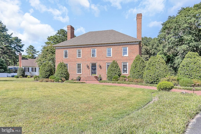 colonial inspired home with a front yard